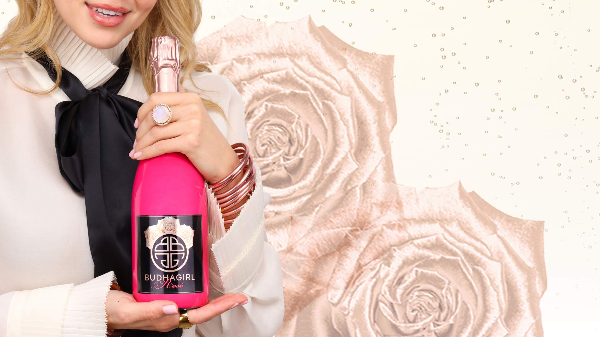 Model Wearing Rose Gold All Weather Bangle Bracelets While Holding a Sparkling Rosé Bottle | BuDhaGirl Sparkling Wines